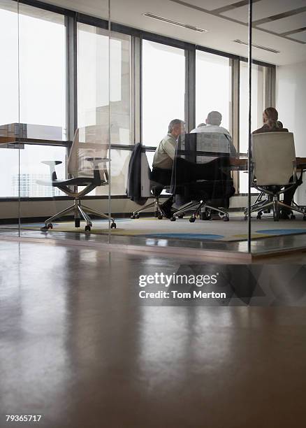 three businesspeople in boardroom - distant meeting stock pictures, royalty-free photos & images