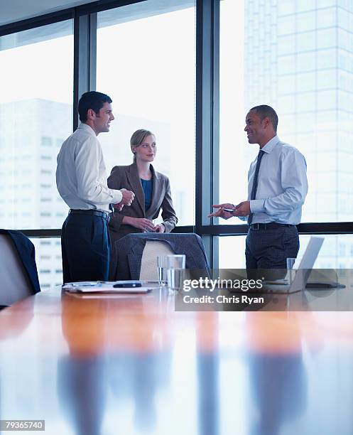 três empresários de pé em uma sala de reuniões - miami business imagens e fotografias de stock
