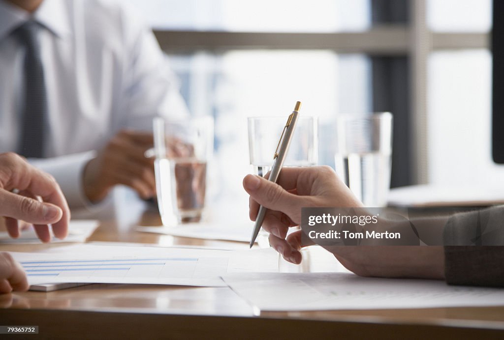 Three businesspeople at a boardroom table