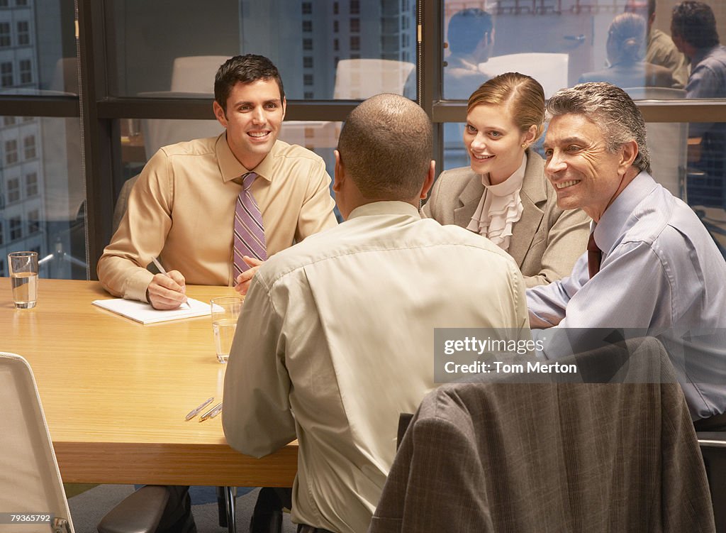 Quatro empresários na sala de reuniões de trabalho