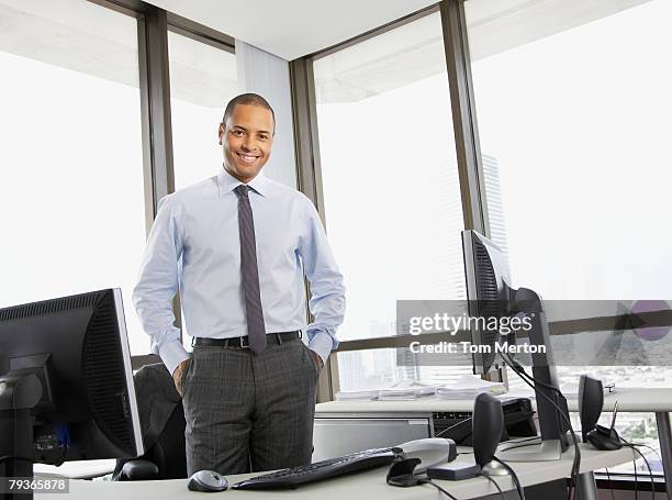businessman standing in office looking at camera - shaved head stock pictures, royalty-free photos & images