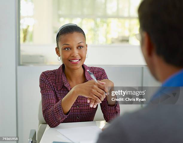two businesspeople in office with notepad - interview preparation stock pictures, royalty-free photos & images