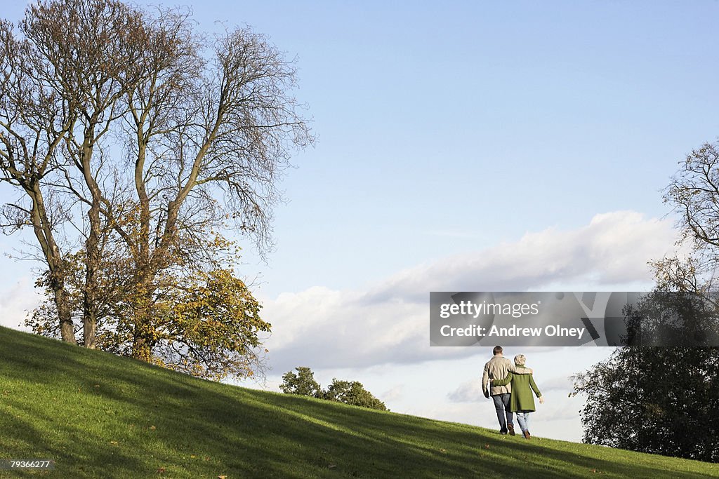 Couple outdoors walking on a hillside