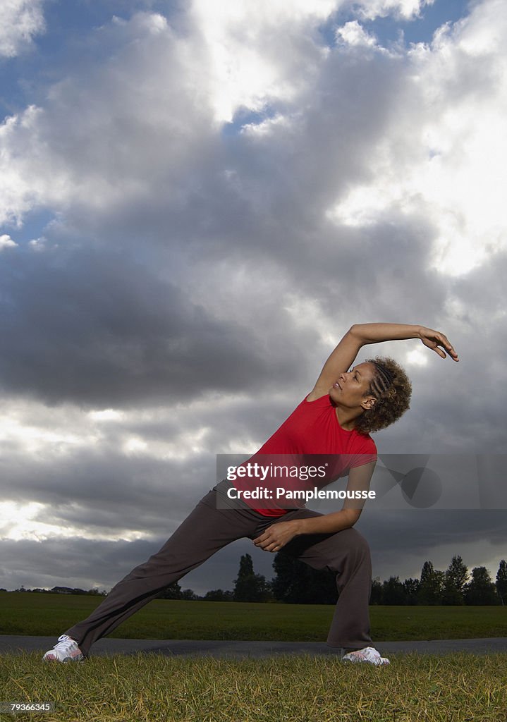 Woman stretching outdoors in a park