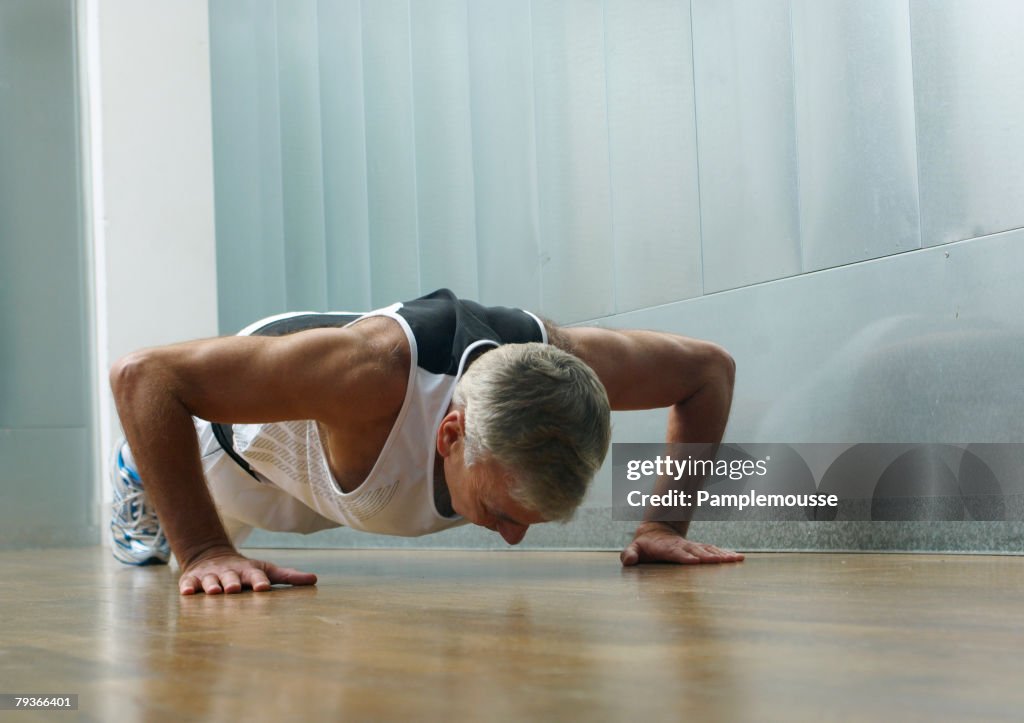 Man in gym doing push-ups