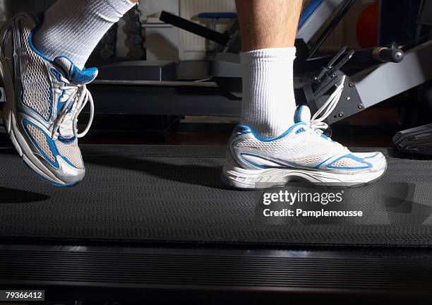 man's feet on a treadmill in a gym - old man feet stock pictures, royalty-free photos & images