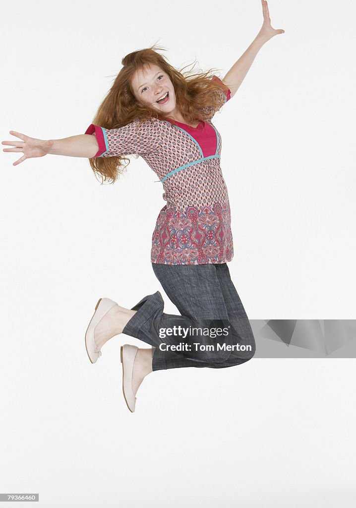 Young girl jumping indoors