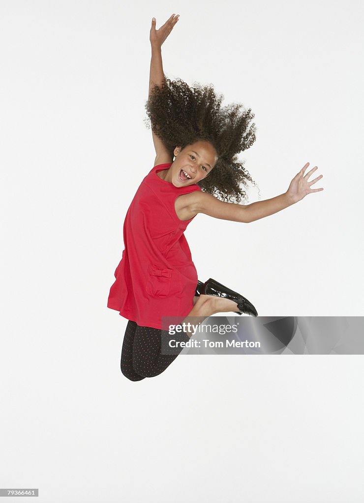 Young girl jumping indoors