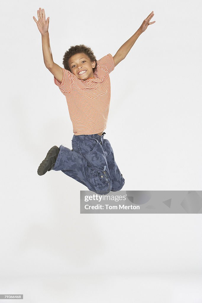 Young boy jumping indoors