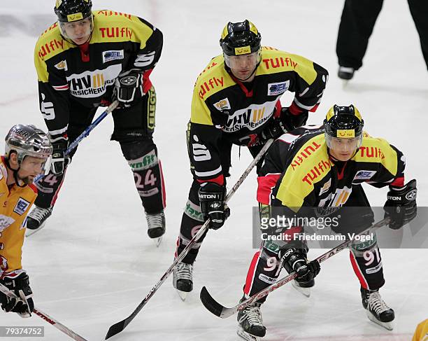 Rene Roethke, Aris Brimanis and Marian Dejdar of Hanover looks on during the DEL match between Hannover Scorpions and DEG Metro Stars at the TUI...