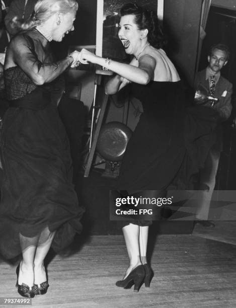 American actresses and dancers Ginger Rogers and Ann Miller perform the Charleston together at the Mocambo nightclub in West Hollywood, February 1950.