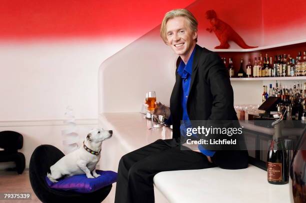 British milliner Philip Treacy with his Jack Russell terrier Mr Pig, photographed at Sketch, London on 3rd September 2003. .