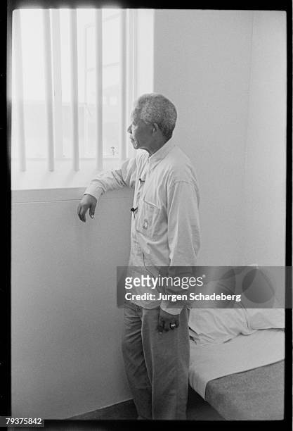 South African president Nelson Mandela revisits his prison cell on Robben Island, where he spent eighteen of his twenty-seven years in prison, 1994.
