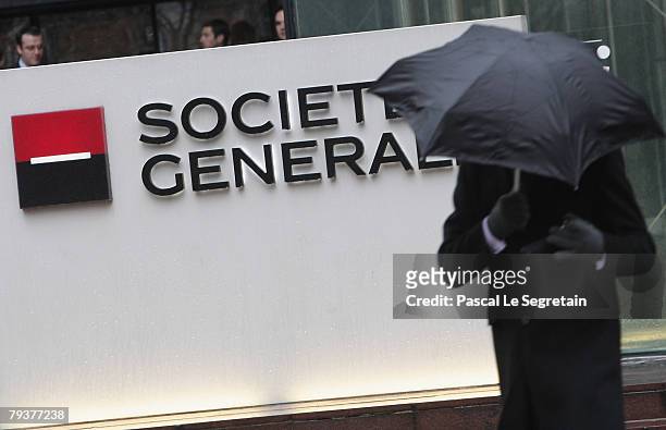 Man walks past the Societe Generale bank logo in front of the entrance of its headquarters on January 30, 2008 in La Defense outside Paris, France....