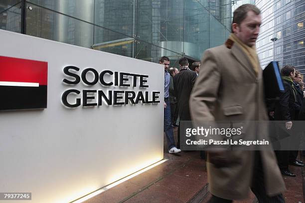 Man walks past the Societe Generale bank logo in front of the entrance of its headquarters on January 30, 2008 in La Defense outside Paris, France....