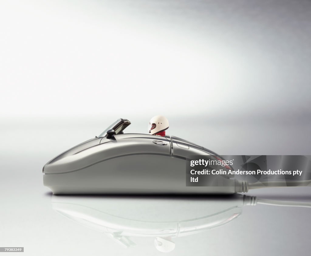 Digital composite of race car driver in computer mouse