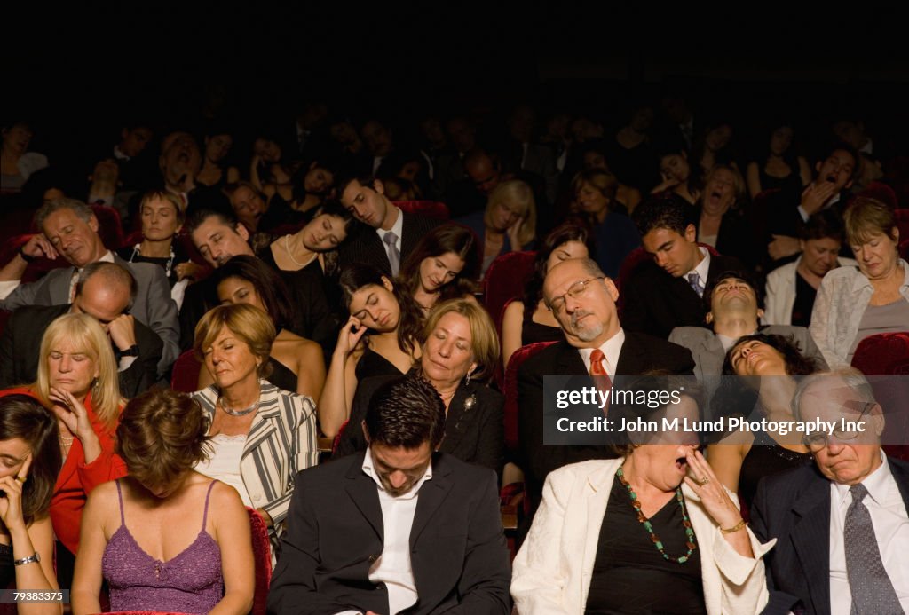 Hispanic people sleeping in theatre