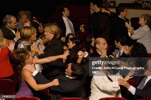 hispanic people fighting in theatre - fighting group stockfoto's en -beelden