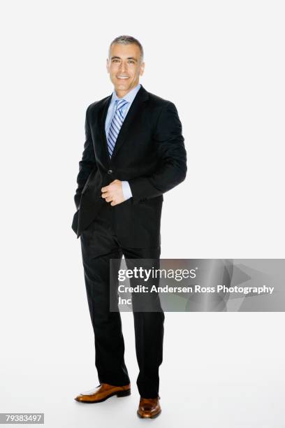 middle eastern businessman with hand on jacket button - traje fotografías e imágenes de stock