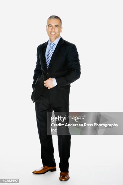 middle eastern businessman with hand on jacket button - full body isolated stockfoto's en -beelden