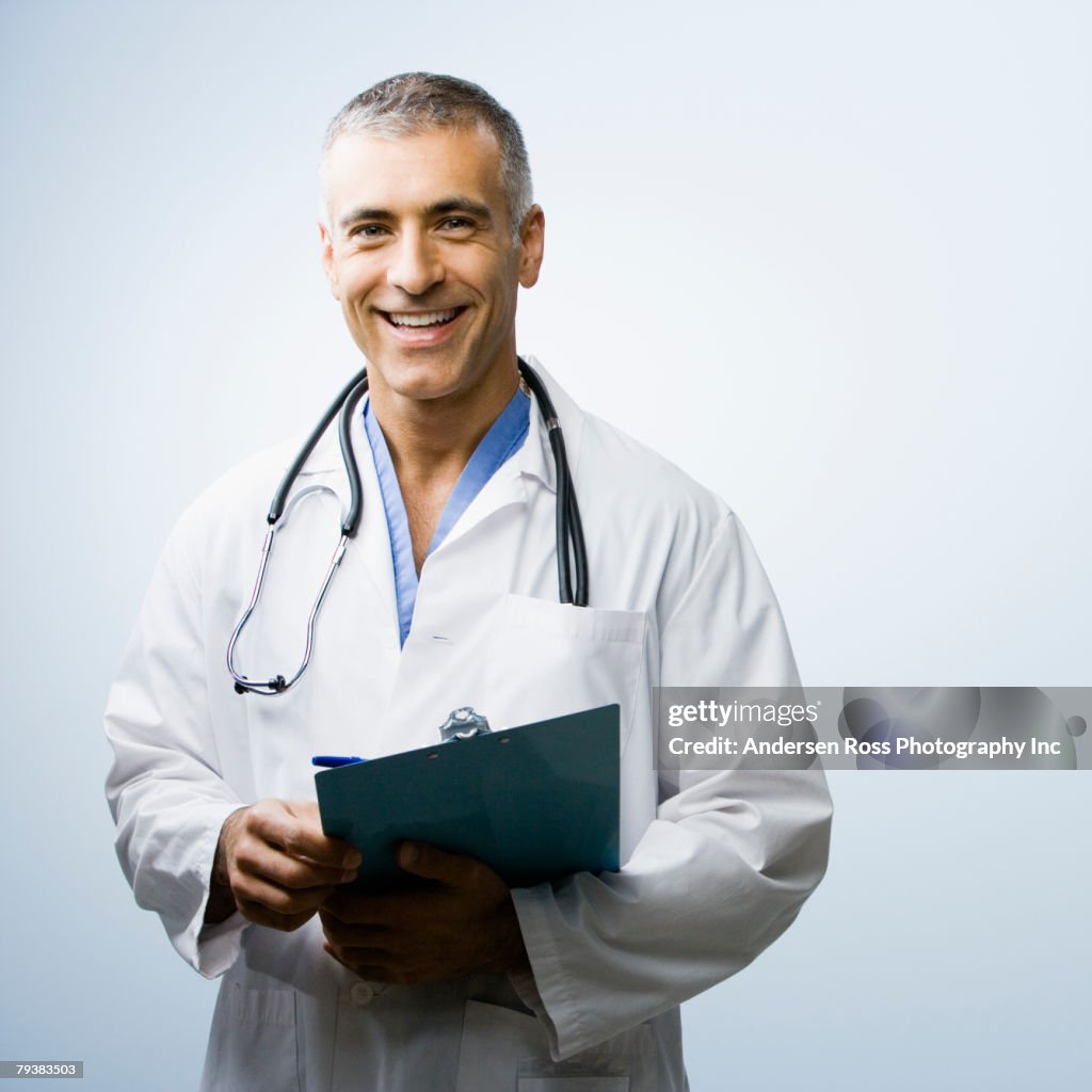 Middle Eastern male doctor holding chart
