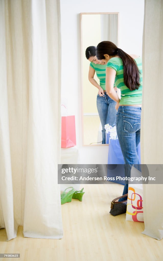 Hispanic woman trying on clothing