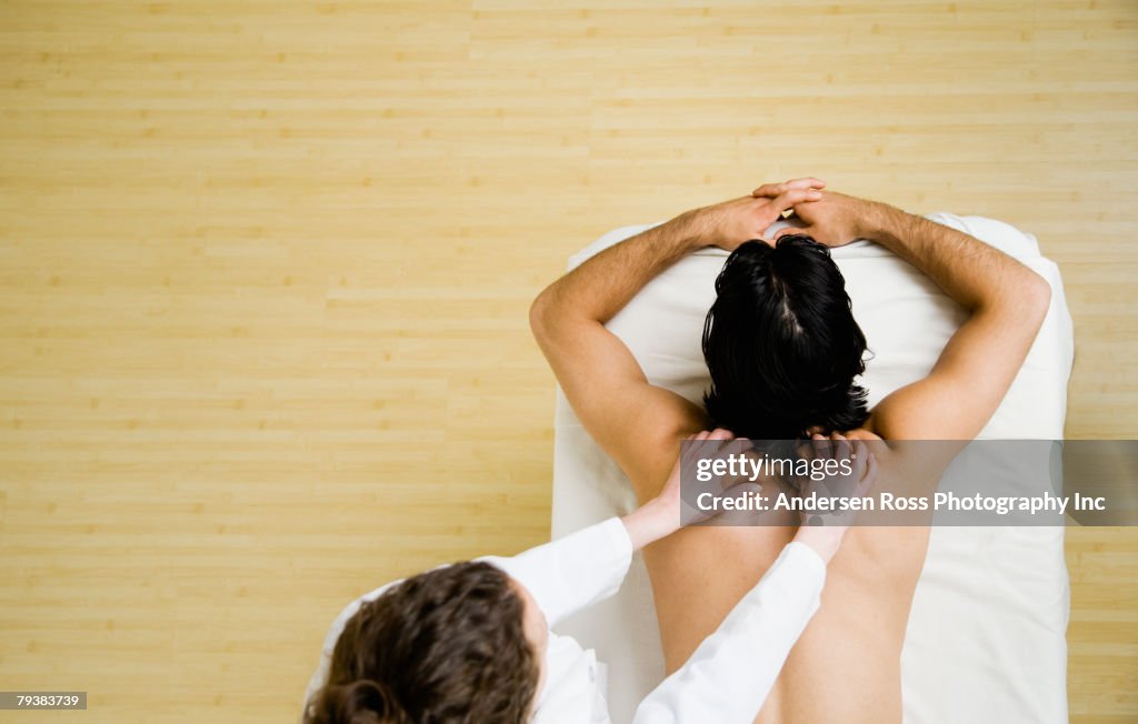 Asian man receiving massage