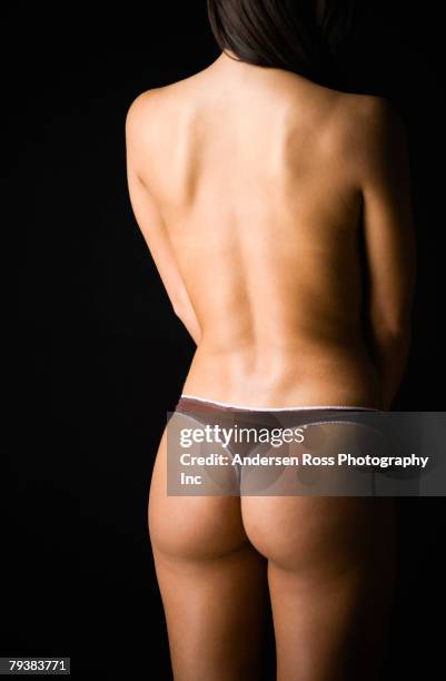 rear view of woman wearing thong underwear - string stockfoto's en -beelden