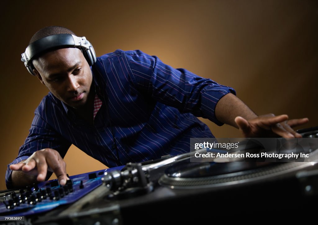 African American male dj spinning records