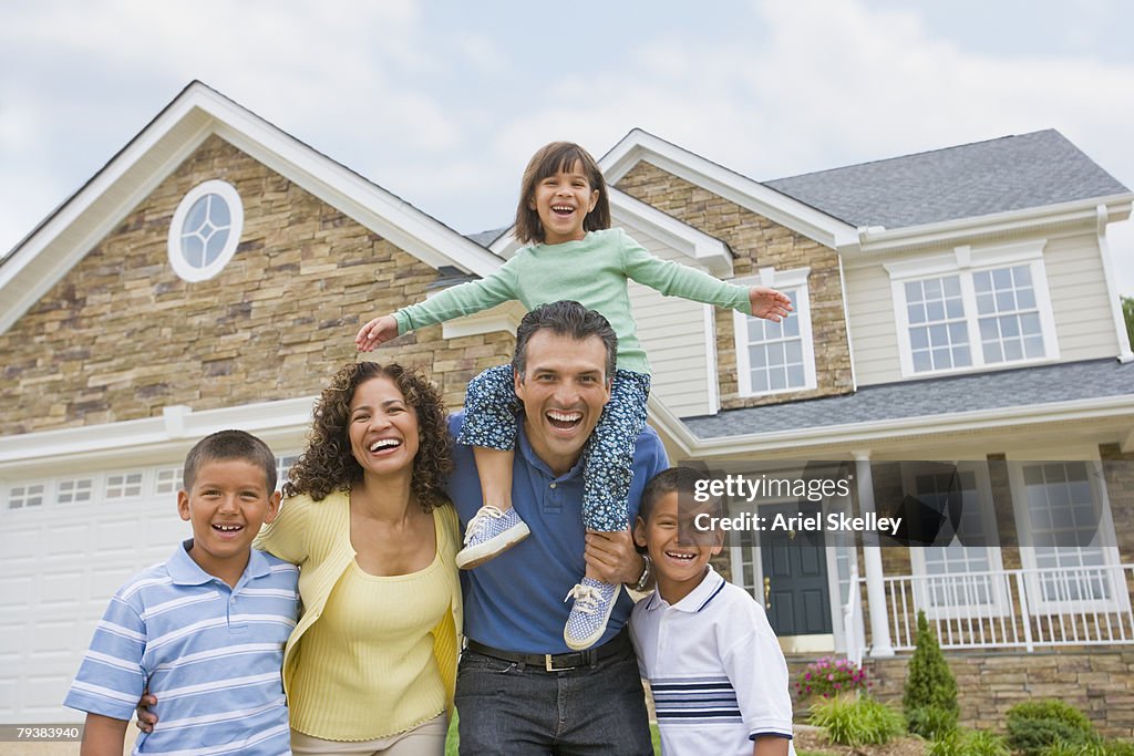 Hispanic family in front of house