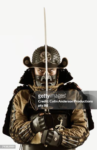 asian man wearing samurai armor - samurai stock-fotos und bilder