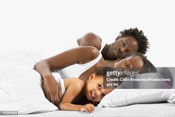 african family sleeping in bed - bed on white stock pictures, royalty-free photos & images
