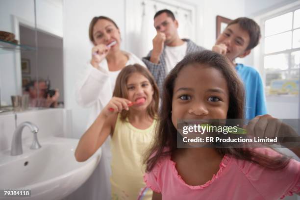 multi-ethnic family brushing teeth - brothers bathroom stock-fotos und bilder