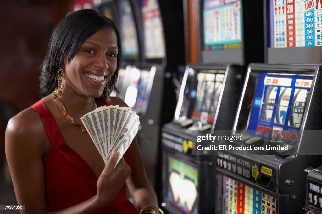 Mixed Race woman holding money