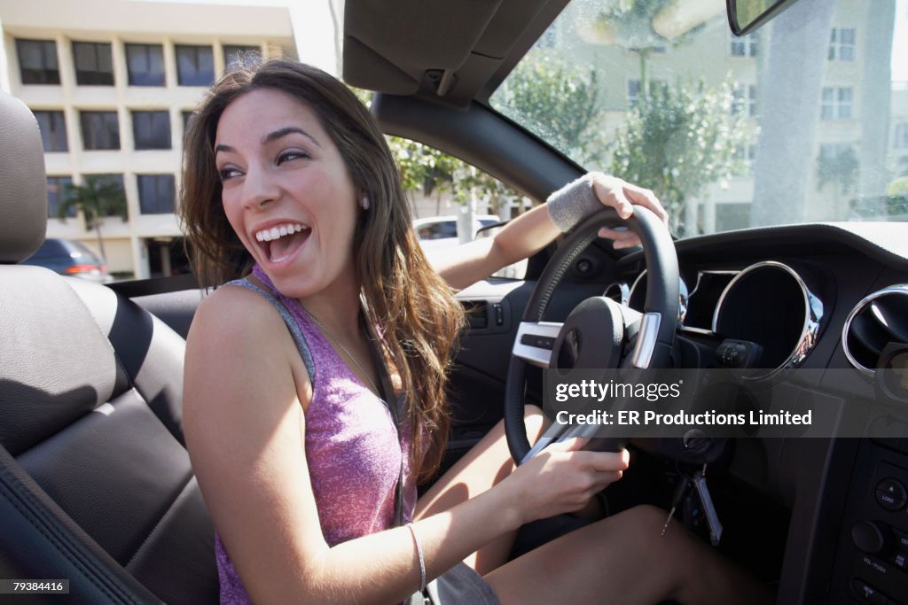 Hispanic woman driving car