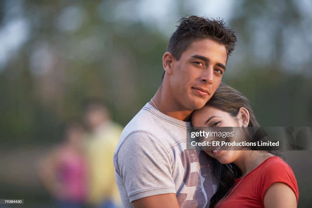 Multi-ethnic couple hugging