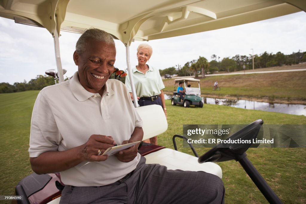 Senior African American man in golf cart