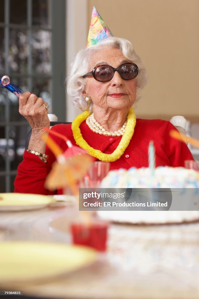 Senior woman with birthday cake