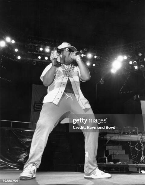 Rapper Sir Mix-A-Lot performs onstage wearing a Mariners jersey and a large gold chain holding a large cell-phone in 1989.