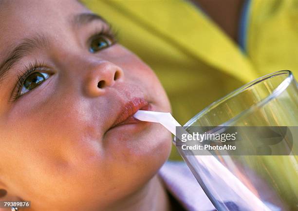 young girl drinking through straw - straw lips stock pictures, royalty-free photos & images