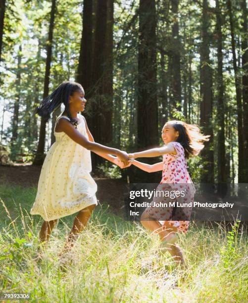 multi-ethnic girls dancing in woods - children dancing outside stockfoto's en -beelden