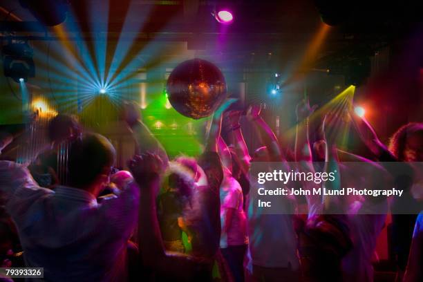 multi-ethnic people dancing at night club - locale notturno foto e immagini stock