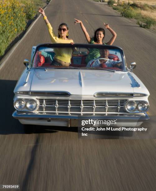 multi-ethnic friends driving in low rider car - ethnic woman driving a car stock pictures, royalty-free photos & images