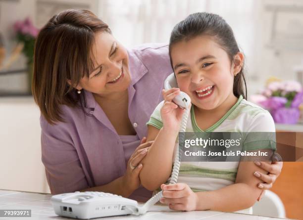 hispanic girl talking on telephone - landline phone home foto e immagini stock