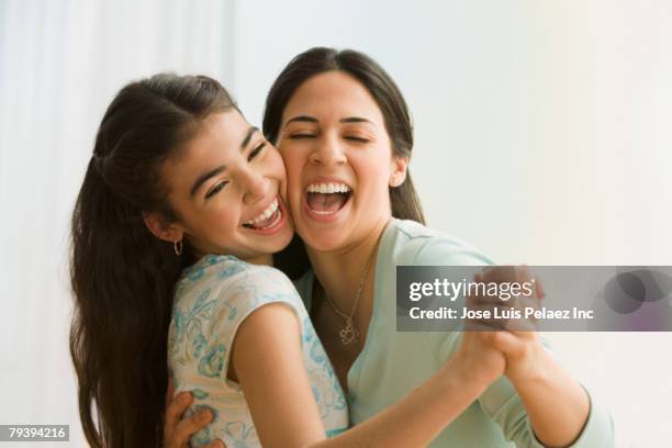 hispanic mother and daughter dancing - family singing stock pictures, royalty-free photos & images