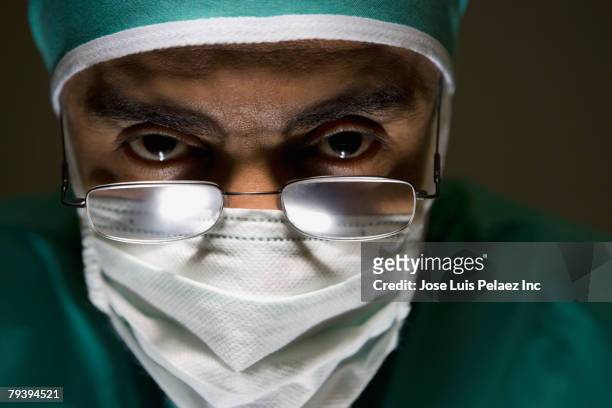 hispanic male doctor wearing surgical mask - wow face man fotografías e imágenes de stock