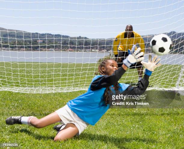 mixed race girl playing soccer - child goalie stock pictures, royalty-free photos & images