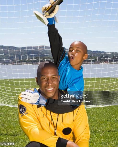 african boy and coach with soccer trophy - title nine imagens e fotografias de stock