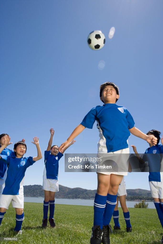 Multi-ethnic children playing soccer