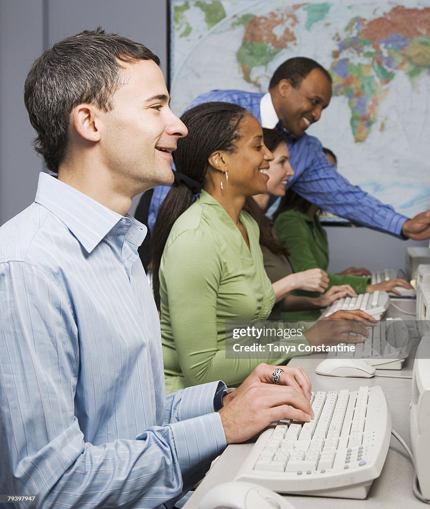 Multi-ethnic businesspeople typing on computers